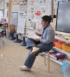 Picture of Ms. Luna reading in front of the classroom